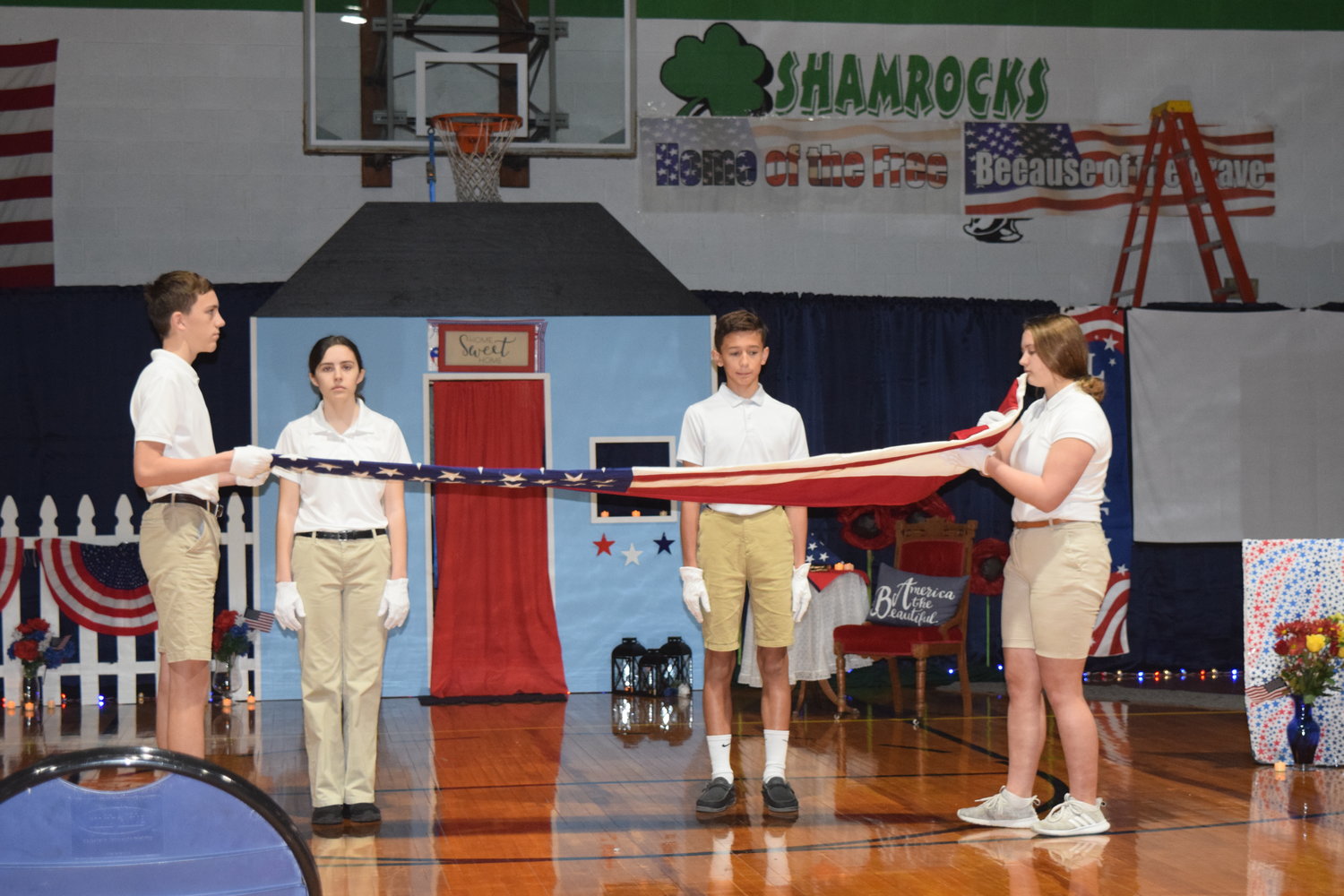 Middle school students at Holy Family School in Hannibal demonstrate the folding of the U.S. Flag and explain the significance of each of the 13 folds during the school’s veterans celebration the day before Veterans Day.